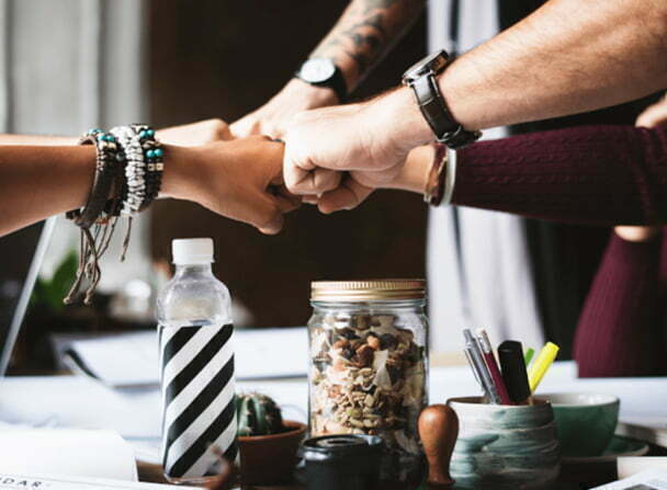 marketing employees huddle