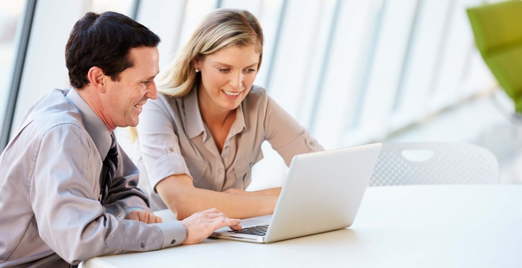 man and woman using a laptop