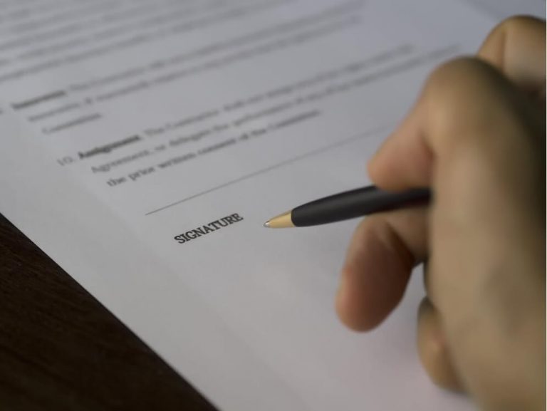 person signing a document